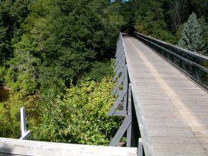 The Musketawa Trail runs for 25 miles between Marne and Muskegon and features 13 wooden trestle bridges. Photo Credit: Friends of Musketawa Trails