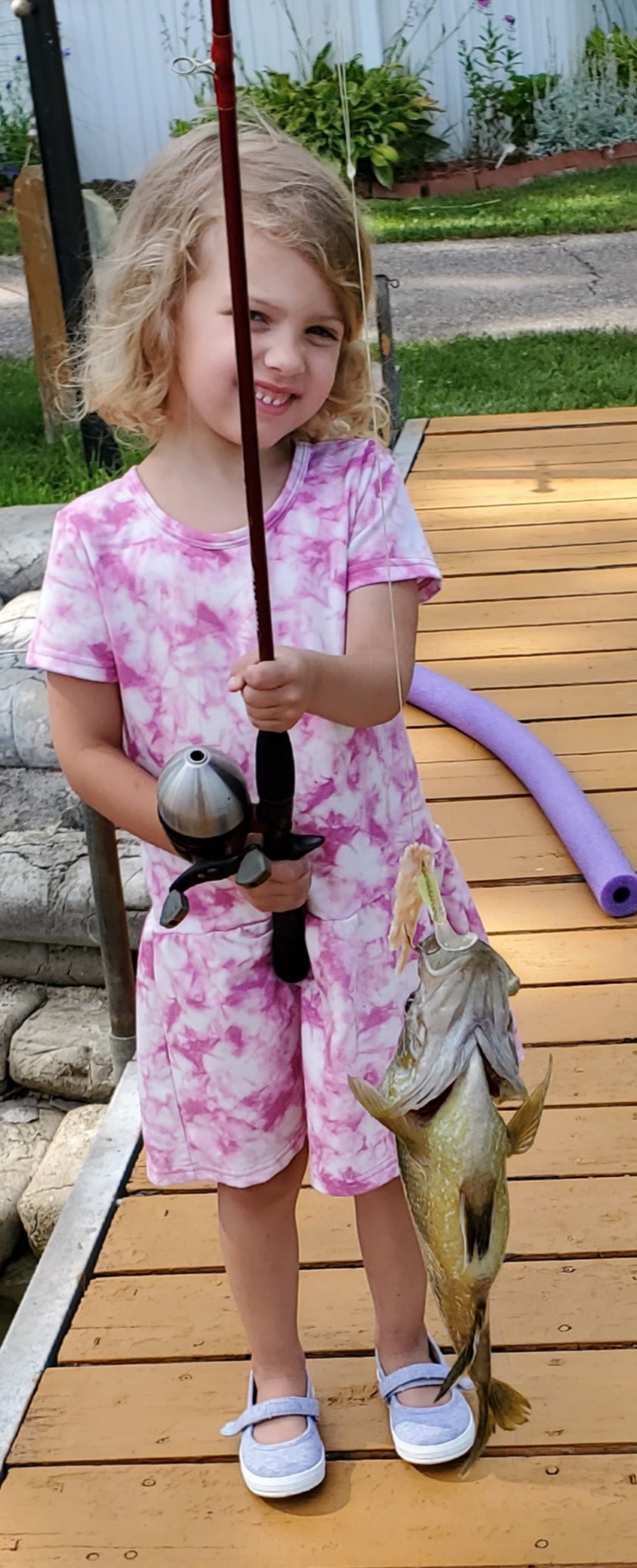 Daughter displays fish she caught