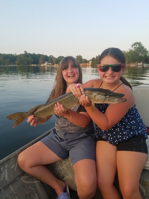 Two young girls holding a 